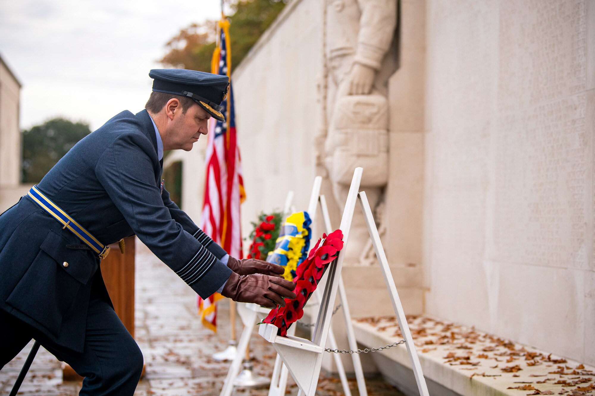 Royal Air Force Group Captain Phil Arnold, RAF High Wycombe commander, lays a wreath along the Tablets of the Missing during a Veterans Day ceremony at Cambridge American Cemetery and Memorial, England, Nov. 9, 2020.The Tablets honor veterans of the past and present for their service to the United States. (U.S Air Force photo by Senior Airman Eugene Oliver)