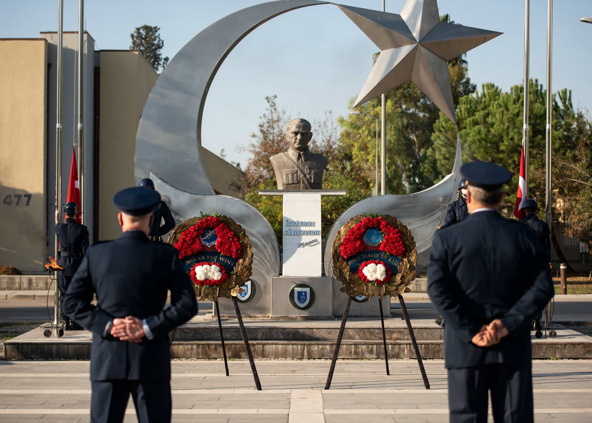 The 10th Tanker Base commander and the 39th Air Base Wing commander stand at parade rest during a ceremony.