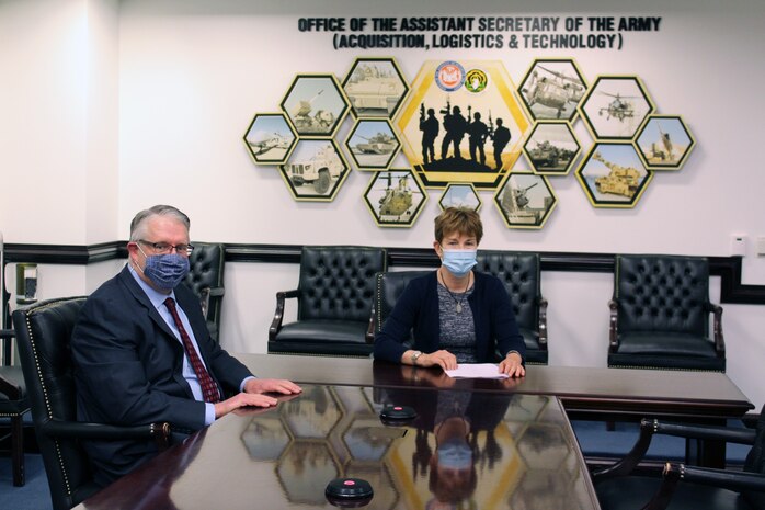 Ms. Elizabeth Wilson, Assistant Deputy Secretary of the Army for Defense Exports and Cooperation, reviews the Cyber Training Capabilities (CTC) Project Arrangement (PA) for Program Executive Office for Simulation, Training and Instrumentation (PEO STRI) with Jim Spratt, from the DASA (DE&C) Armaments Cooperation Directorate.