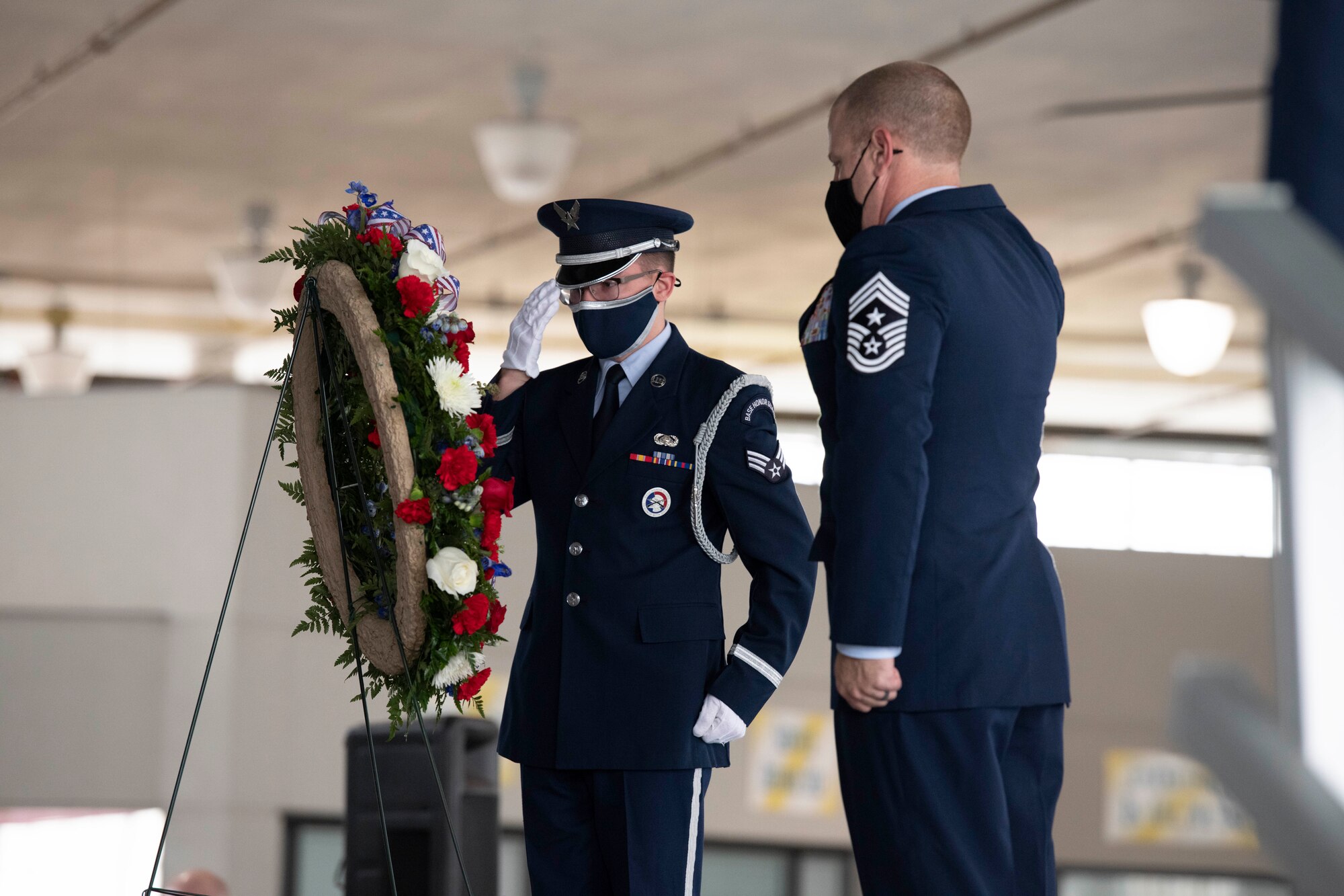 A Maxwell Air Force Base Honor Guard member salutes the wreath alongside Chief Master Sgt. Michael Morgan, 42nd Air Base Wing command chief, Nov. 11, 2020. (U.S. Air Force photo by Senior Airman Charles Welty)