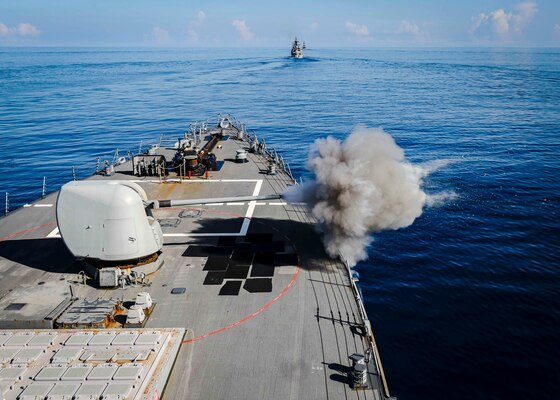 The Arleigh Burke-class guided-missile destroyer USS John S. McCain (DDG 56) fires its mark 45 5-inch gun during a live-fire gunnery exercise with ships from multiple nations as part of Malabar 2020. Malabar is an India-led multinational exercise designed to enhance cooperation between Indian Navy (IN), Royal Australian Navy (RAN), Japan Maritime Self-Defense Force (JMSDF) and U.S. maritime forces. Australian, Indian, Japanese and American maritime forces routinely operate together in the Indo-Pacific, fostering a cooperative approach toward regional security and stability.