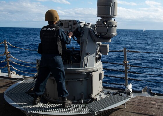 Gunner's Mate 3rd Class Kristen Elkins, from Villa Rica, Ga., fires a 25mm machine gun during a live-fire gunnery exercise aboard the Arleigh Burke-class guided-missile destroyer USS Curtis Wilbur (DDG 54). Curtis Wilbur is assigned to Destroyer Squadron (DESRON) 15, the Navy's largest forward-deployed DESRON and the U.S. 7th Fleet's principal surface force.