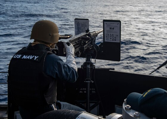 Gunner's Mate Seaman Ryan Mason, from Fort Worth, Texas, fires a .50-caliber machine gun during a live-fire gunnery exercise aboard the Arleigh Burke-class guided-missile destroyer USS Curtis Wilbur (DDG 54). Curtis Wilbur is assigned to Destroyer Squadron (DESRON) 15, the Navy's largest forward-deployed DESRON and the U.S. 7th Fleet's principal surface force.