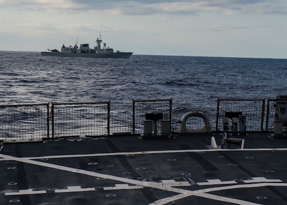 The Halifax-class frigate HMCS Winnipeg (FFH 338) sails with the Arleigh Burke-class guided-missile destroyer USS Curtis Wilbur (DDG 54) prior to a live-fire gunnery exercise. Curtis Wilbur is assigned to Destroyer Squadron (DESRON) 15, the Navy's largest forward-deployed DESRON and the U.S. 7th Fleet's principal surface force.