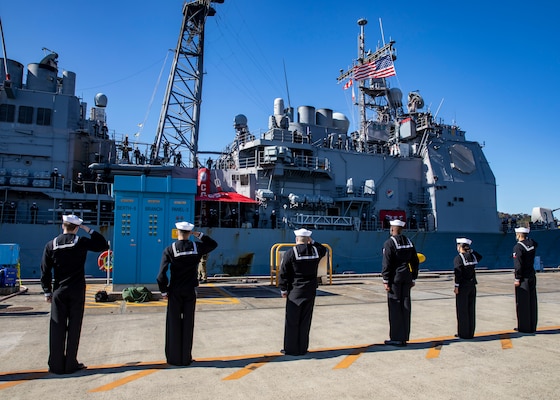 Sailors assigned to the Ticonderoga-class guided-missile cruiser USS Antietam (CG 54) salute as the ship arrives at Commander, Fleet Activities Yokosuka.