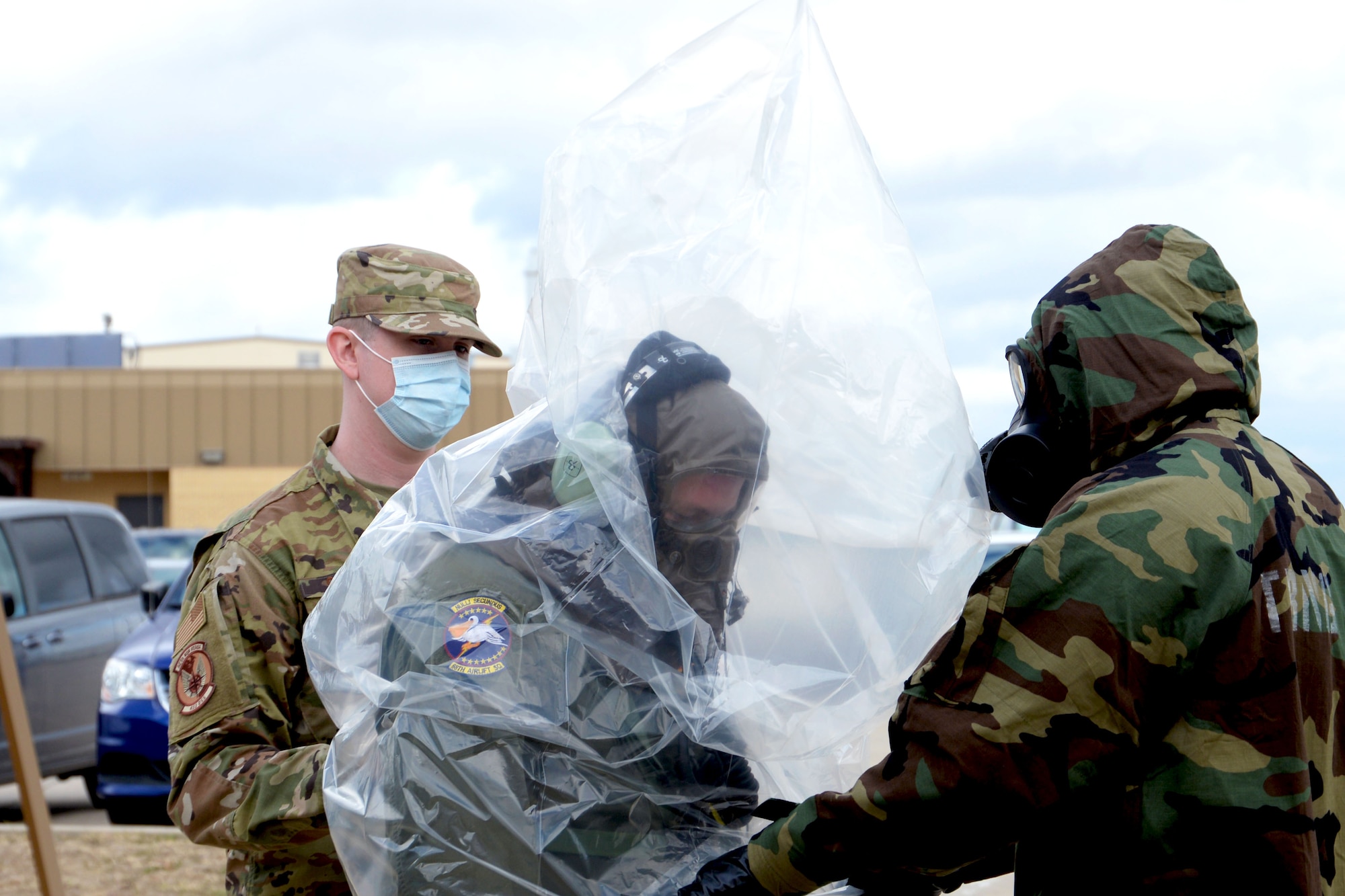 Tech. Sgt. Eric Oestreich, 68th Airlift Squadron loadmaster, wears a plastic cover while being processed for decontamination Nov. 8, 2020, at Joint Base San Antonio-Lackland, Texas. Oestreich, along with other 68th AS and 433rd Operations Support Squadron Airmen, practiced decontamination procedures in order to maintain readiness. (U.S. Air Force photo by Tech. Sgt. Samantha Mathison)