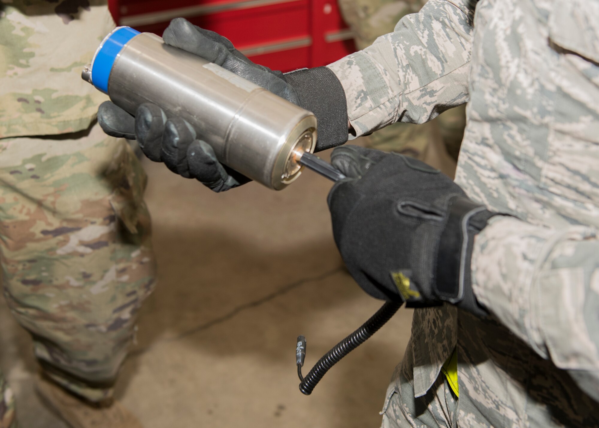 U.S. Air Force Airman 1st Class George Antuna, a 3rd Munitions Squadron precision-guided munitions technician, installs a cable assembly into a fuze at a combat munitions training class at Joint Base Elmendorf-Richardson, Alaska, Nov. 5, 2020. U.S. Air Force Tech. Sgt. Nicholas Kern, the 3rd MUNS training section chief, revamped his squadron’s training section and implemented an expanded CMT program that familiarizes ammo troops with a variety of munitions in one location.