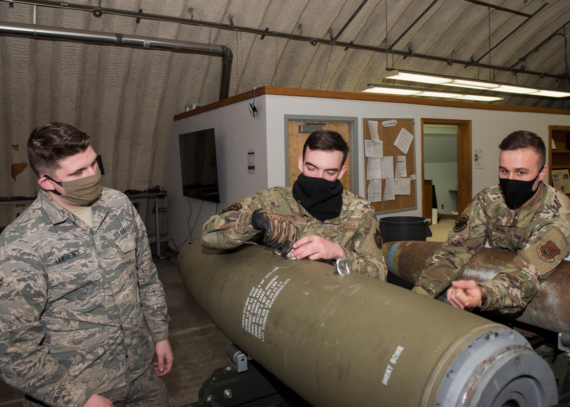 U.S. Air Force Tech. Sgt. Nicholas Kern, right, the 3rd Munitions Squadron training section chief, provides combat munitions training to U.S. Air Force Airman 1st Class Joshua Lawrence, left, a 3rd MUNS stockpile management technician, and U.S. Air Force Airman 1st Class Kyle Krus, a 3rd MUNS conventional maintenance technician, at Joint Base Elmendorf-Richardson, Alaska, Nov. 5, 2020. Kern revamped his squadron’s training section and implemented an expanded CMT program that familiarizes ammo troops with a variety of munitions in one location.