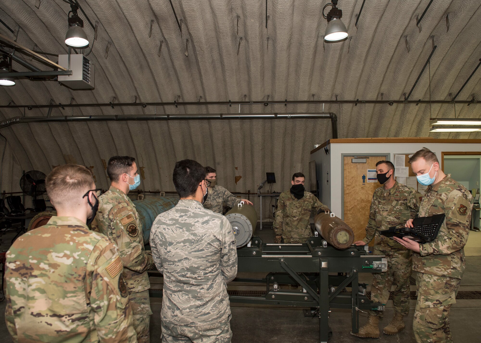 U.S. Air Force Tech. Sgt. Nicholas Kern, second from right, the 3rd Munitions Squadron training section chief, teaches a combat munitions training class at Joint Base Elmendorf-Richardson, Alaska, Nov. 5, 2020. Kern revamped his squadron’s training section and implemented an expanded CMT program that familiarizes ammo troops with a variety of munitions in one location.