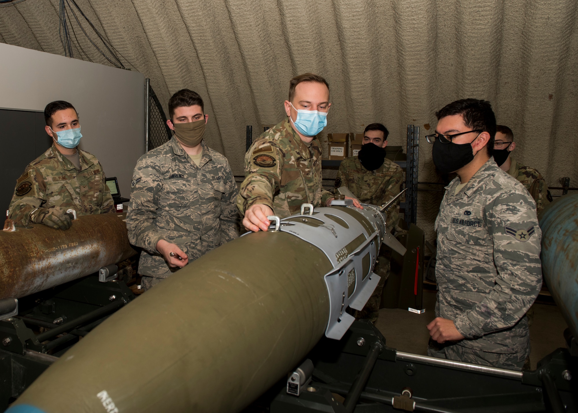 U.S. Air Force Staff Sgt. Jacob Smith, third from left, the 3rd Munitions Squadron training supervisor, teaches a combat munitions training class at Joint Base Elmendorf-Richardson, Alaska, Nov. 5, 2020. U.S. Air Force Tech. Sgt. Nicholas Kern, the 3rd MUNS training section chief, revamped his squadron’s training section and implemented an expanded CMT program that familiarizes ammo troops with a variety of munitions in one location.