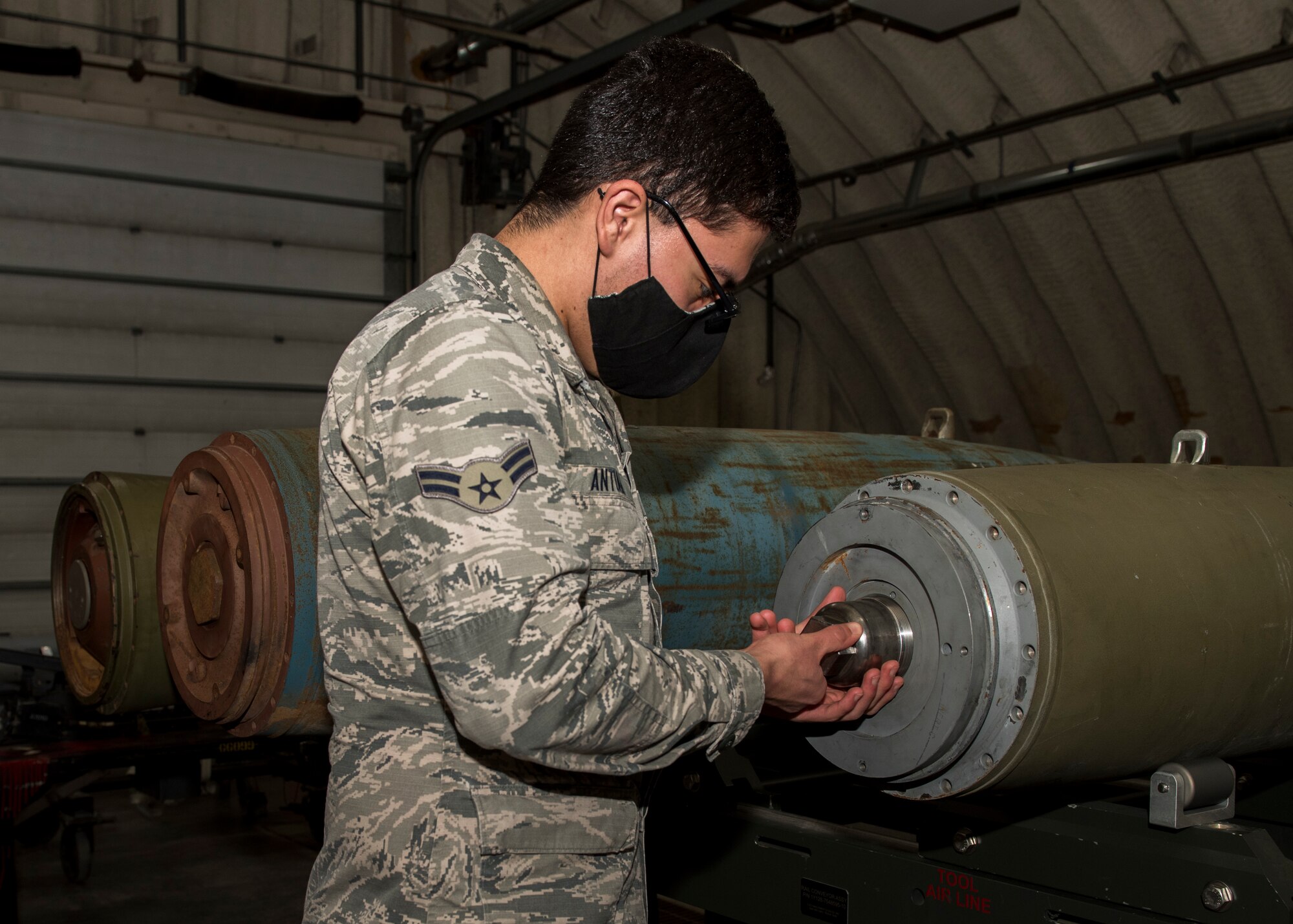 U.S. Air Force Airman 1st Class George Antuna, a 3rd Munitions Squadron precision guided munitions technician, disassembles an inert bomb at a combat munitions training class at Joint Base Elmendorf-Richardson, Alaska, Nov. 5, 2020. U.S. Air Force Tech. Sgt. Nicholas Kern, the 3rd MUNS training section chief, revamped his squadron’s training section and implemented an expanded CMT program that familiarizes ammo troops with a variety of munitions in one location.