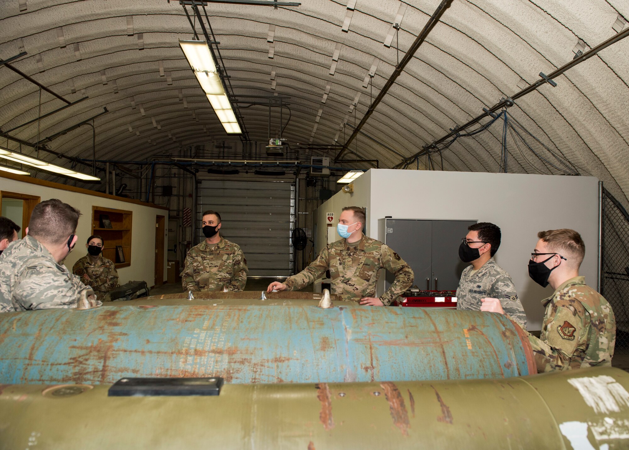 U.S. Air Force Tech. Sgt. Nicholas Kern, fourth from right, the 3rd Munitions Squadron training section chief, teaches a combat munitions training class at Joint Base Elmendorf-Richardson, Alaska, Nov. 5, 2020. Kern revamped his squadron’s training section and implemented an expanded CMT program that familiarizes ammo troops with a variety of munitions in one location.