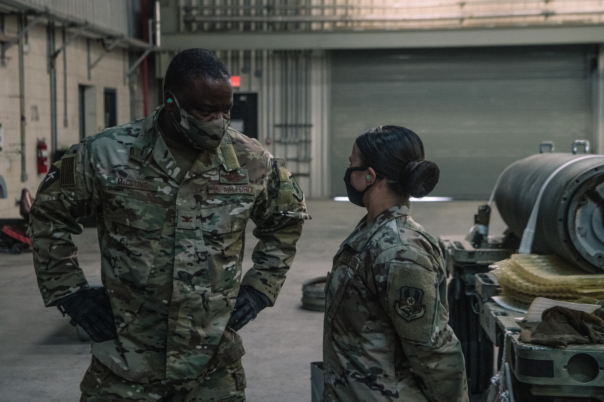 U.S. Air Force Col. John C. McClung, left, 379th Air Expeditionary Wing Vice Commander, speaks with Senior Airman Angelica Range, a conventional maintenance crewmember, about the munitions loading process during a hands-on demonstration at the Munitions Storage Area on Al Udeid Air Base, Qatar, Nov. 4, 2020. Range assisted Col. McClung on how to safely process the ammunition through the Universal Ammunition Loading System. (U.S. Air National Guard photo by Staff Sgt. Jordan Martin)