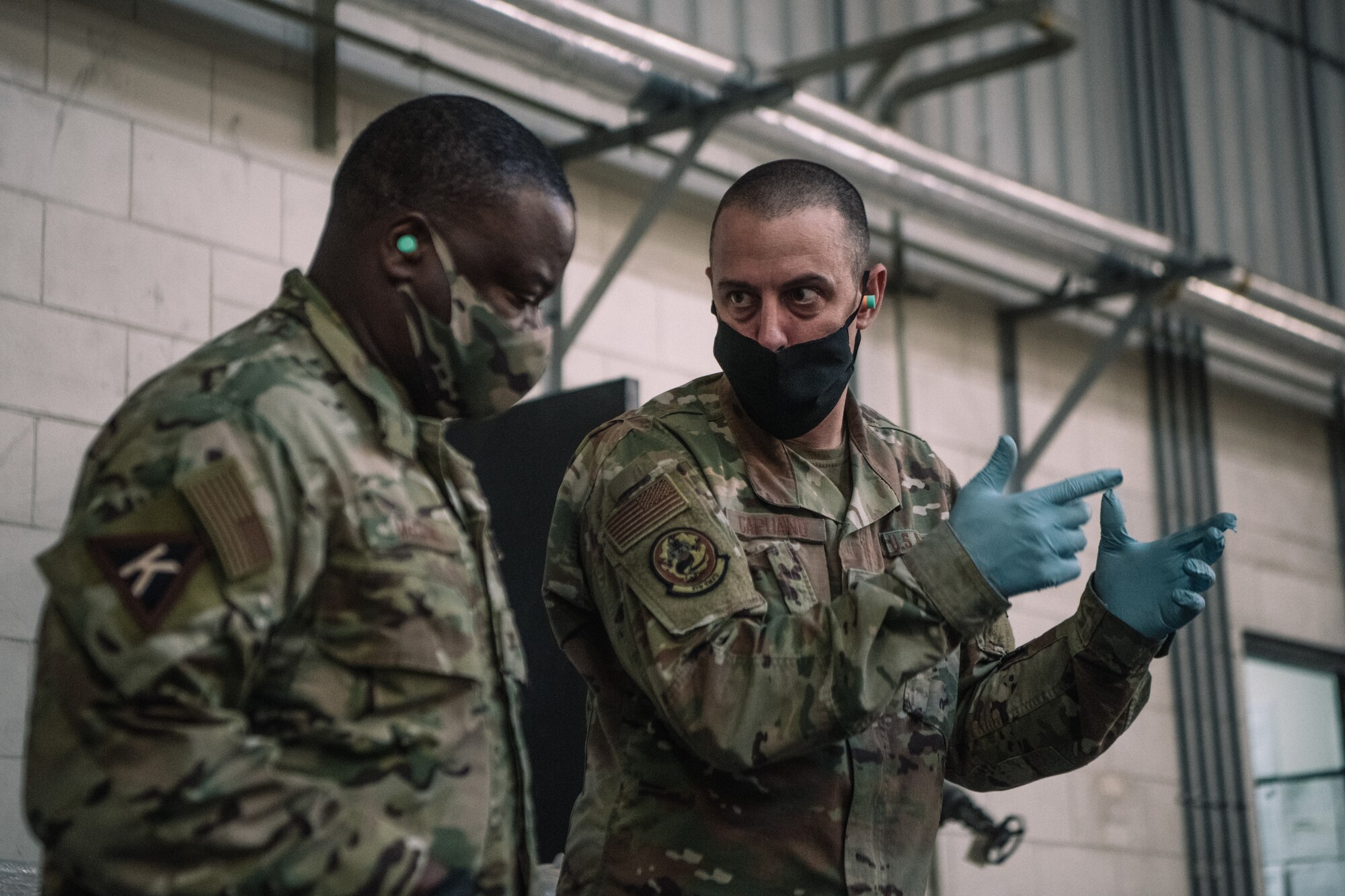 Master Sgt. Richard Capuano, right, munitions flight chief, guides U.S. Air Force Col. John C. McClung, left, 379th Air Expeditionary Wing Vice Commander, through a hands-on ammunition processing demonstration at the Munitions Storage Area on Al Udeid Air Base, Qatar, Nov. 4, 2020. McClung had the opportunity to load over 500 rounds of 20 mm ammunition into the Universal Ammunition Loading System. (U.S. Air National Guard photo by Staff Sgt. Jordan Martin)