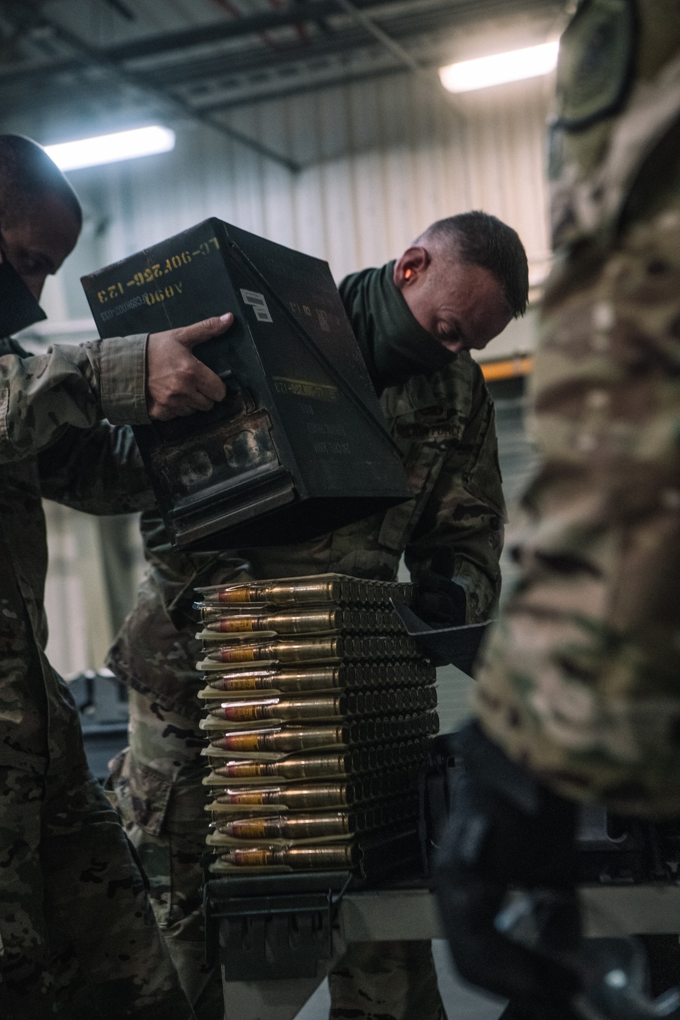 Chief Master Sgt. Michael Sullivan, 379th Expeditionary Maintenance Group (379th EMXG) Superintendent, unloads boxes of 20 mm ammunition before loading into the Universal Ammunition Loading System (UALS), at the Munitions Storage Area on Al Udeid Air Base, Qatar, Nov. 5, 2020. The ammunition is fed into the UALS before being transported to the flight line and loaded directly onto an aircraft. (U.S. Air National Guard photo by Staff Sgt. Jordan Martin)