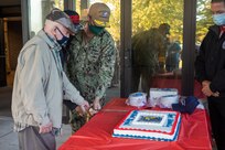 Norfolk Naval Shipyard Commander Rear Admiral Howard Markle hosted a cake cutting during the annual Veterans Day Fall-In for Colors Nov. 10. He was joined by Oscar Thorpe and Rashad Williams, the oldest and youngest veterans employed at America’s Shipyard.