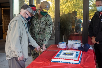 Norfolk Naval Shipyard Commander Rear Admiral Howard Markle hosted a cake cutting during the annual Veterans Day Fall-In for Colors Nov. 10. He was joined by Oscar Thorpe and Rashad Williams, the oldest and youngest veterans employed at America’s Shipyard.