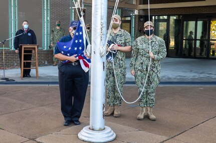 Retired NNSY Employee Rick Nelson and members of the NNSY Command Duty Office raise the flag over America’s Shipyard during the Veterans Day Fall-In For Colors Nov. 10.