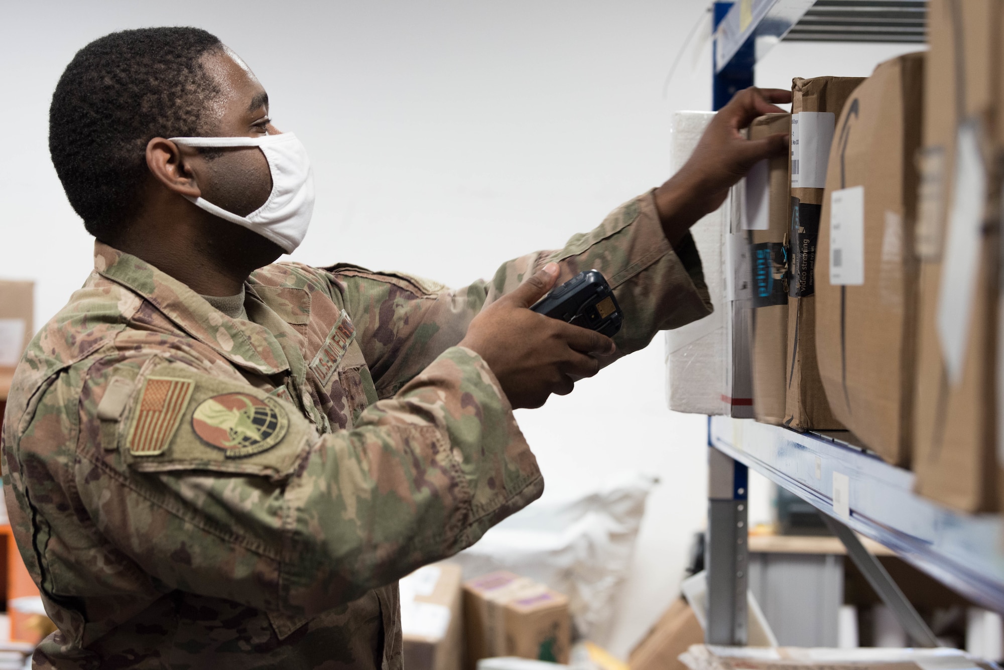 An Airman scans a package in the Northside Post Office at Ramstein Air Base.