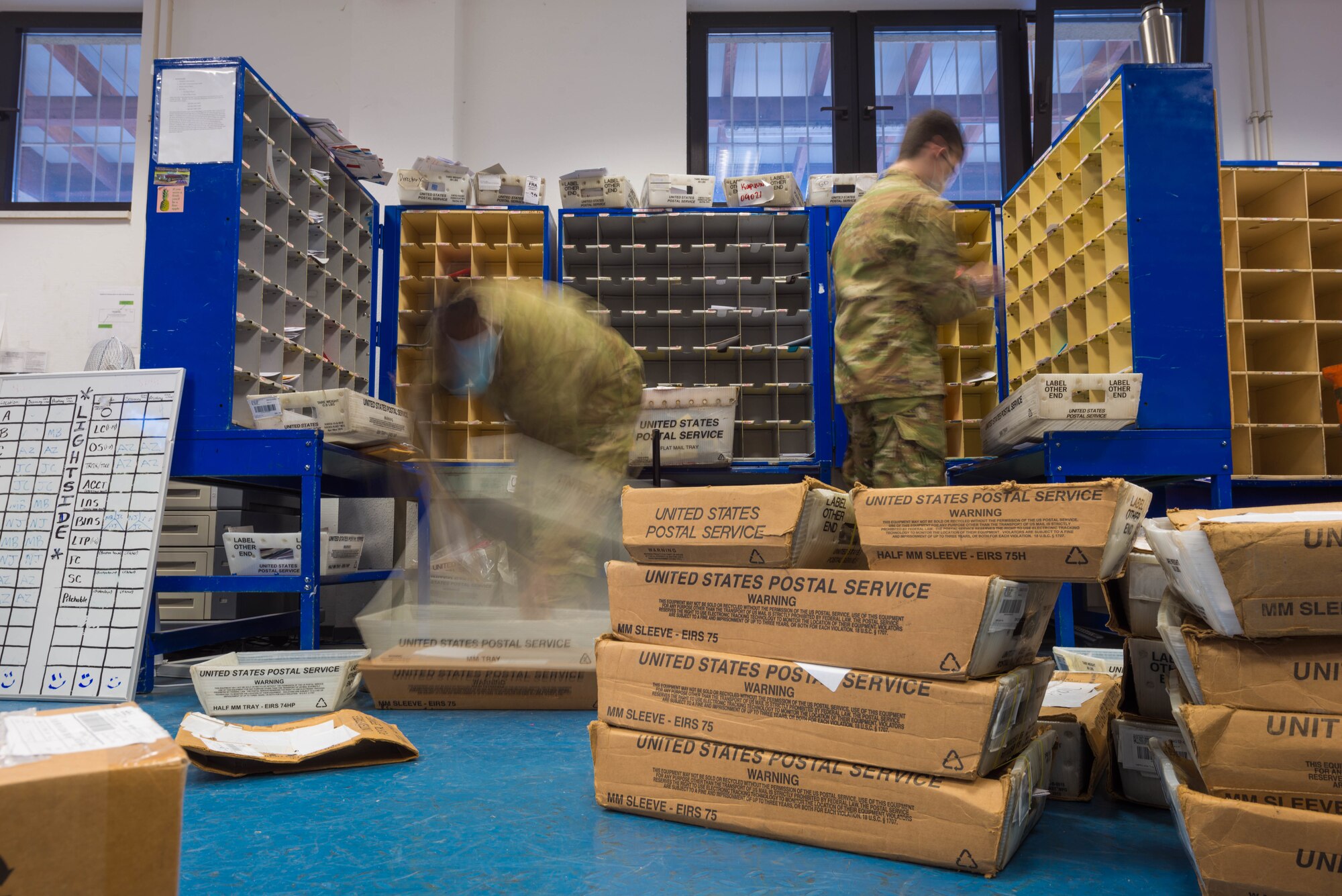 Two Airman sort through mail in the Northside Post Office at Ramstein Air Base.