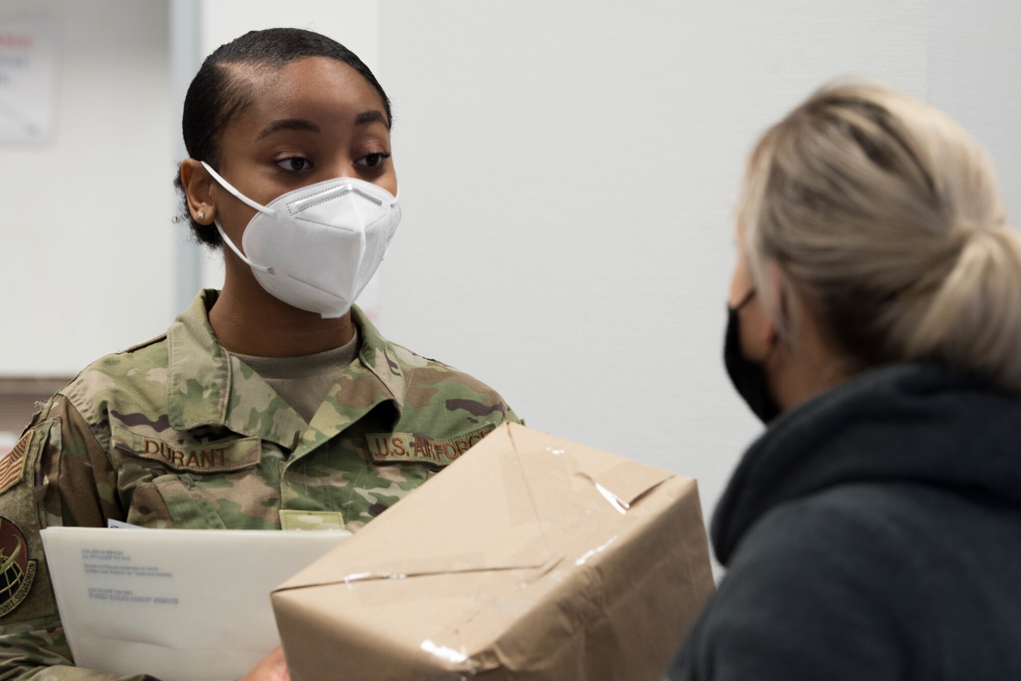 An Airman assists a customer in the Northside Post Office at Ramstein Air Base, Germany.
