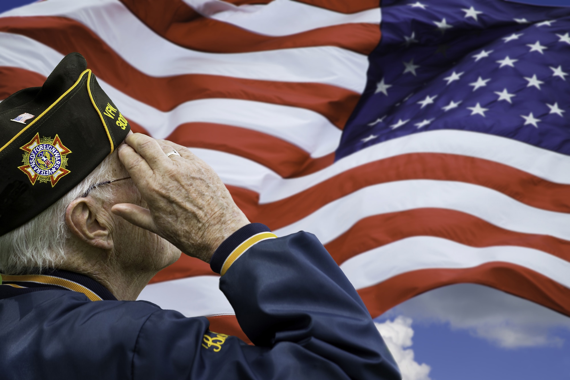 photo shows a veteran saluting the U.S. flag