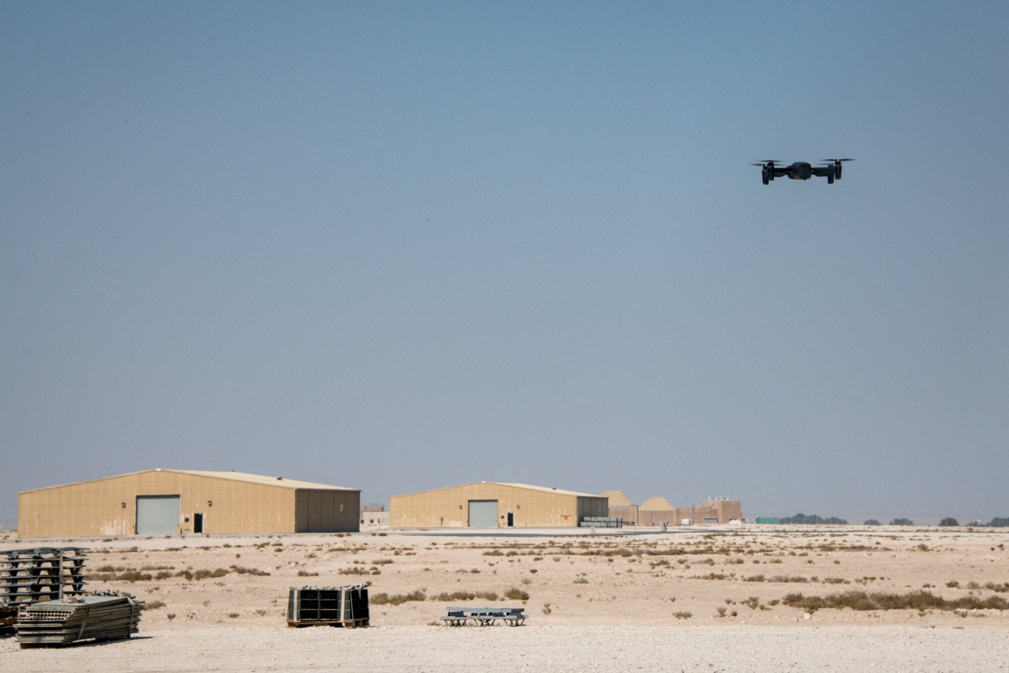 Drone hovers above ground