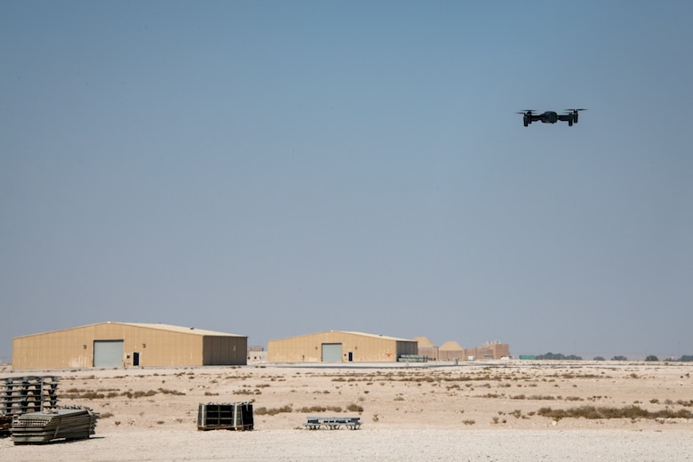 Drone hovers above ground