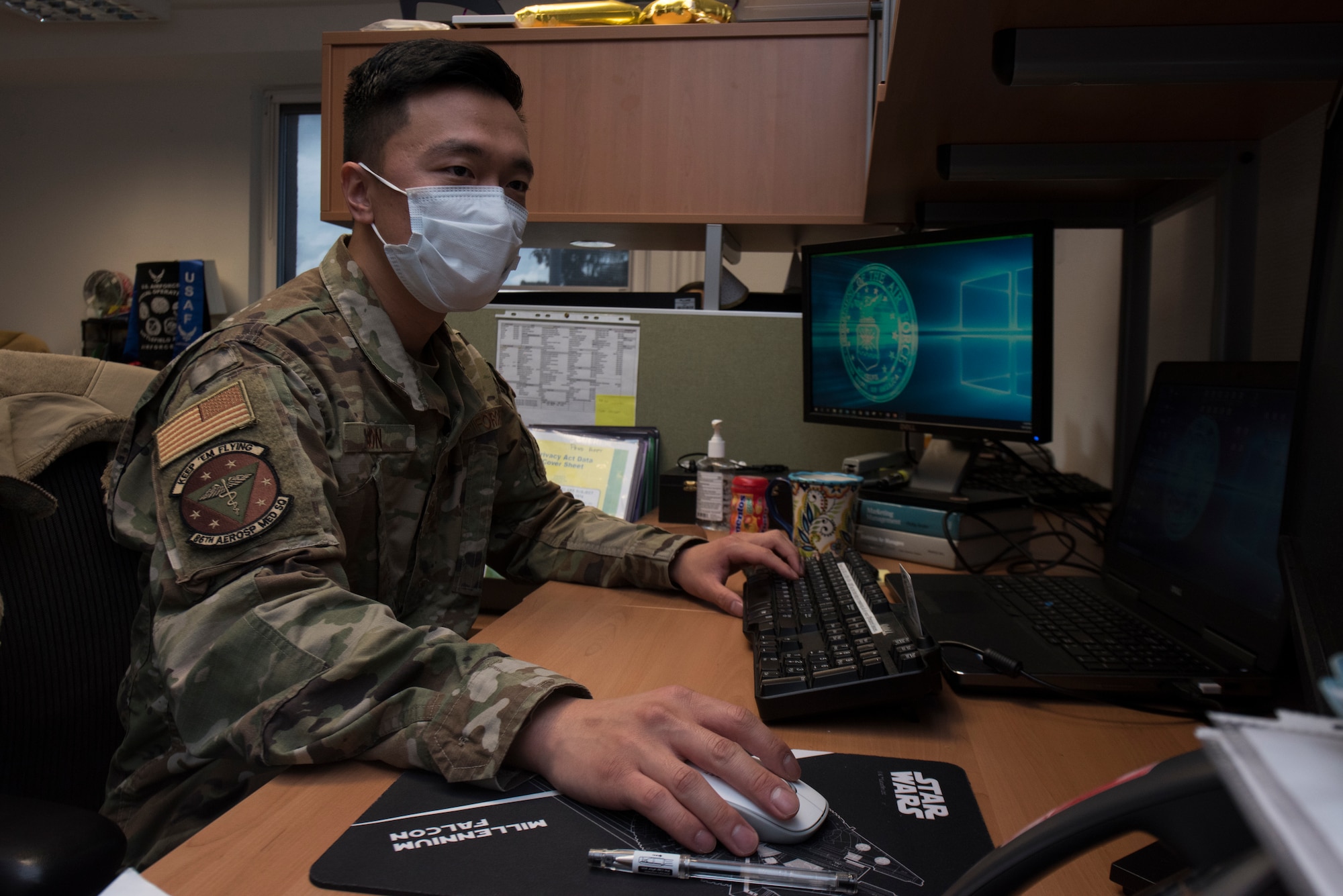 An Airman checks documents on a computer.