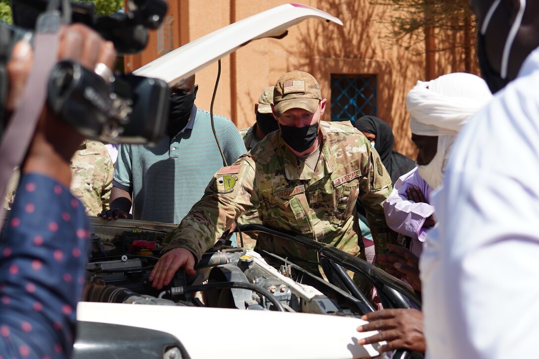 U.S. Air Force Staff Sgt. Jeffrey Urquhart, 724th Logistics Readiness Flight vehicle maintenance technician, briefs repairs that were made on an unserviceable ambulance to medical staff and media at the District Sanitaire Commune d'Agadez clinic in Agadez, Niger, Oct. 30, 2020. In total, the repairs took two months, 96 hours of labor and gave back 1.5 million CFA Franc to the local economy by purchasing parts from local businesses.