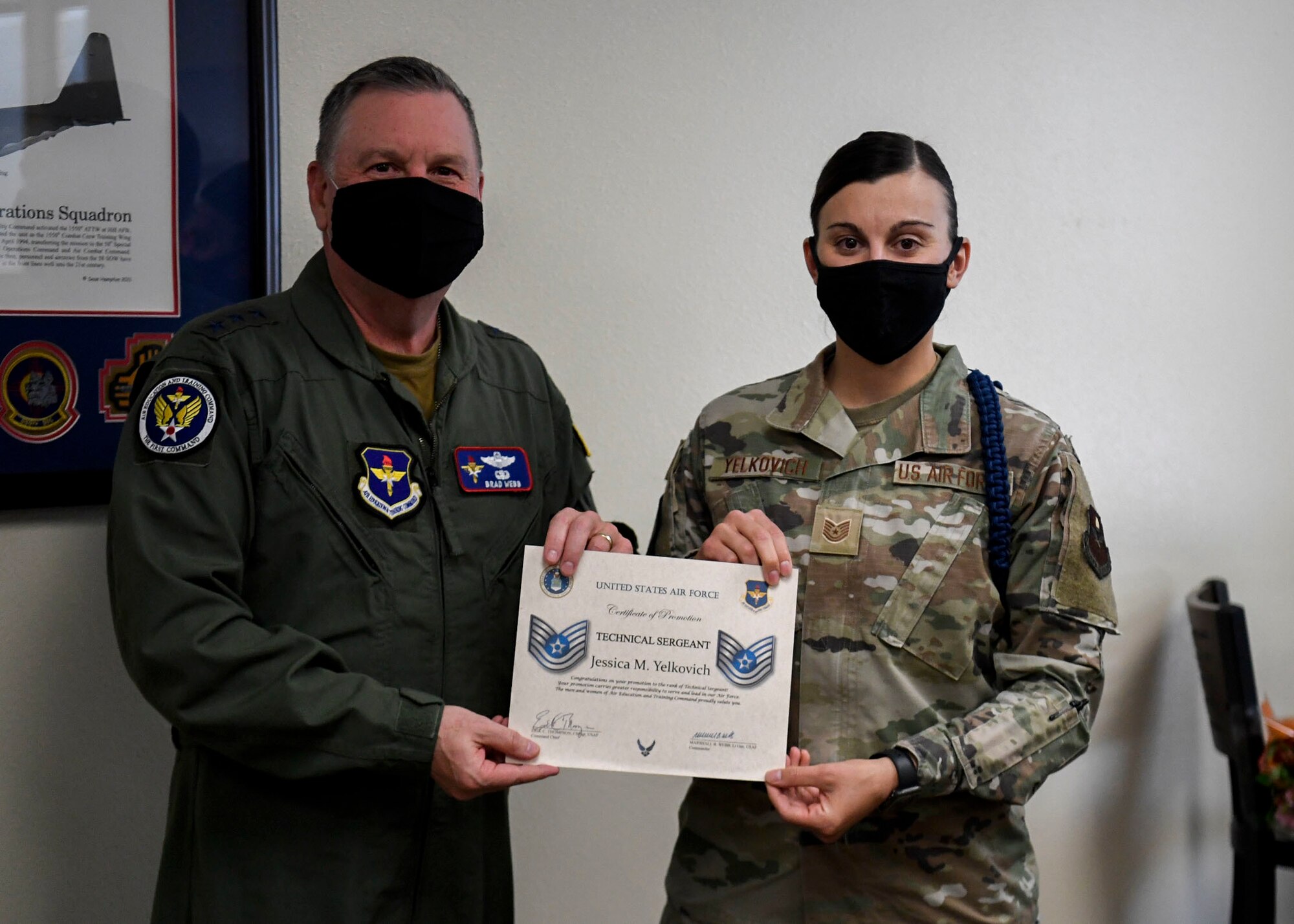 AETC commander presents certificate of promotion to Tech. Sgt. Jessica M. Yelkovich.