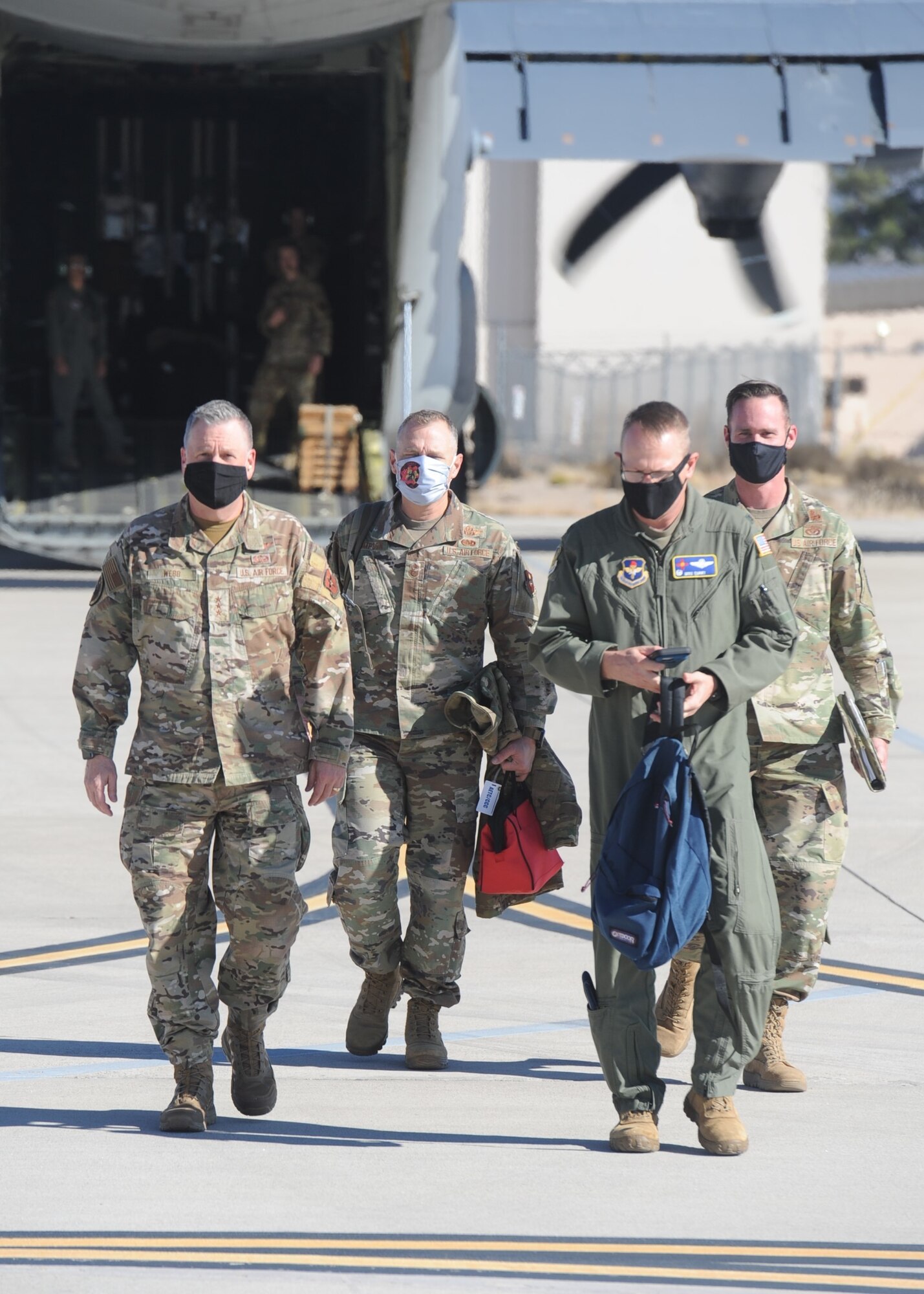 AETC senior leaders walk from aircraft to hangar.