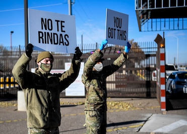Airmen hold up signs of support.