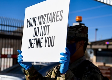 An Airman holds up a sign of support.