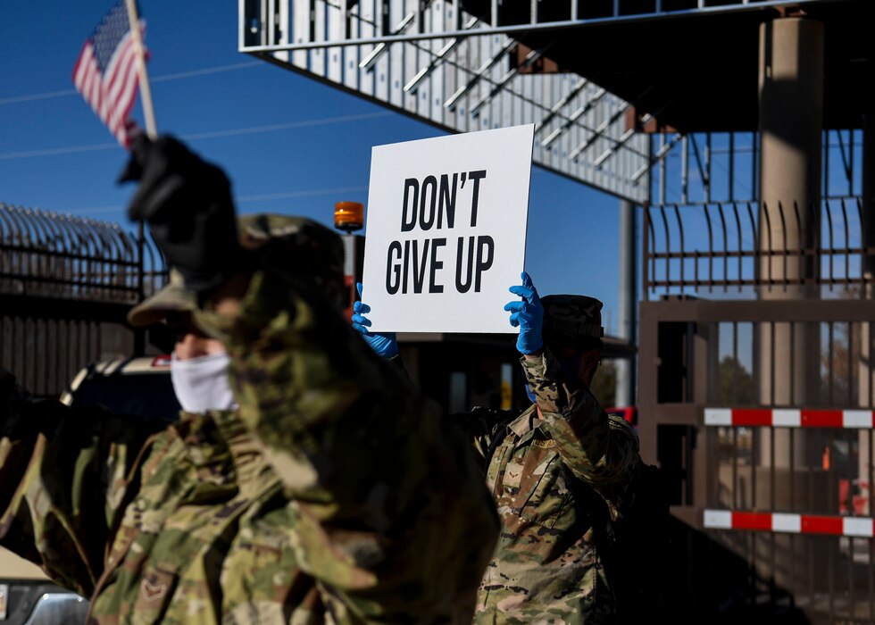 Airman hold up signs of support.