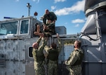 During egress testing, a test dummy was removed from the Landing Craft Air Cushion command area to simulate removing an injured troop through the emergency escape scuttle. Pictured above: Senior Chief Operations Specialist Josh Pearsall. Pictured below: Intelligence Specialist 2nd Class Daniel Boatwright, Lt.j.g. Dale Hussung, and Builder 1st Class Richard Bordelon.