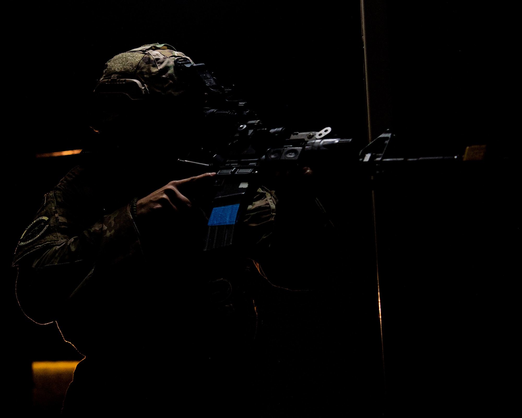 A member of the 633rd Security Forces Squadron enters a room.