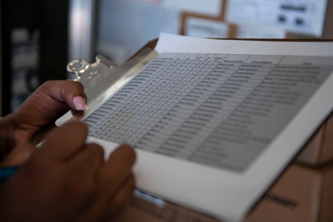A photo of an Airman checking serial numbers.