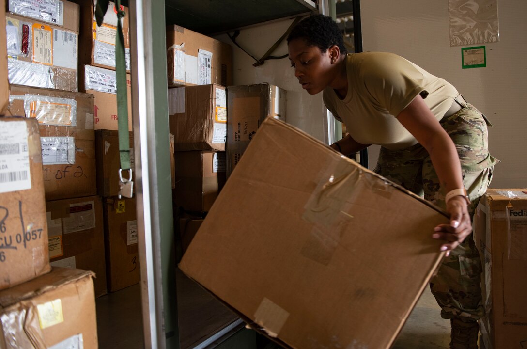 A photo of an Airman loading equipment into a package.