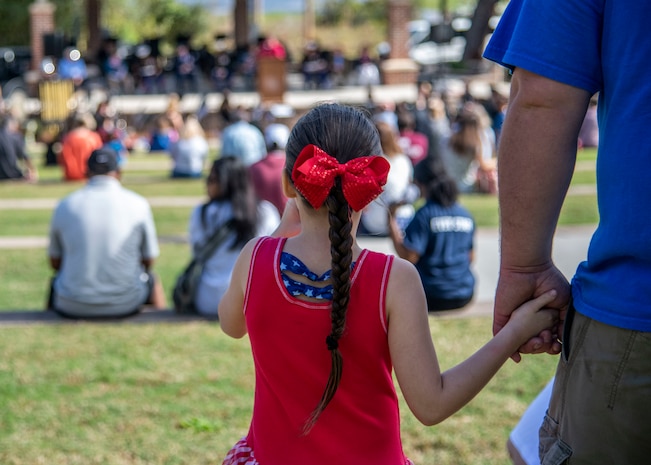 Members of the local community listen to guest speakers at the 8th annual Red, White and Blue Festival at the Hanahan Amphitheater, in Hanahan, S.C., November 7, 2020. Mayor Christie Rainwater, City of Hanahan mayor, and members of Joint Base Charleston and U.S. Marine Corps Recruiting Station Columbia also spoke about the importance of Veterans Day at the event. Additionally, the Joint Base Charleston Honor Guard presented the colors of each branch of service while the Charleston Southern University Concert Band played the official songs of the Army, Marine Corps, Navy, Air Force and Coast Guard.