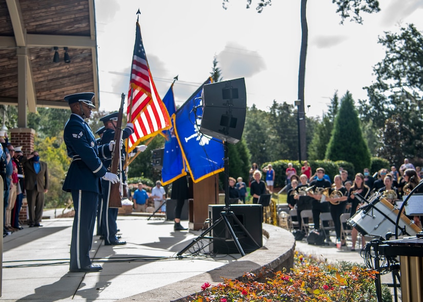 The Joint Base Charleston Honor Guard presents the colors while the Charleston Southern University Concert Band plays the national anthem at the 8th annual Red, White and Blue Festival at the Hanahan Amphitheater, in Hanahan, S.C., November 7, 2020. Mayor Christie Rainwater, City of Hanahan mayor, and members of Joint Base Charleston and U.S. Marine Corps Recruiting Station Columbia spoke about the importance of Veterans Day at the event.