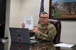 Sgt. Maj. Frank Leone III of the West Virginia National Guard Recruiting and Retention Battalion holds the 2020 Rhododendron Award which he received Nov. 12, 2020. Leone was recognized by West Virginia First Lady Cathy Justice for his outstanding contributions to fellow West Virginians through receipt of the award, which aims to recognize individuals in West Virginia who have demonstrated goodness and worked for the betterment of their communities. (U.S. Air National Guard photo by Maj. Holli Nelson)