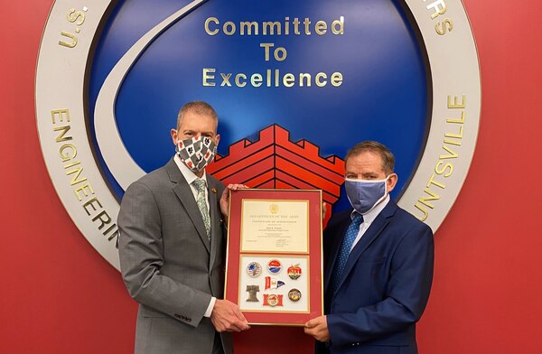 Albert "Chip" Marin III, U.S. Army Engineering and Support Center programs director, (pictured right) presents a U.S. Army Certificate of Achievement to Alan Fearns, contracting officer, for successful completion of the U.S. Army Corps of Engineers North Atlantic Division's Executive Leadership Developmental Program.