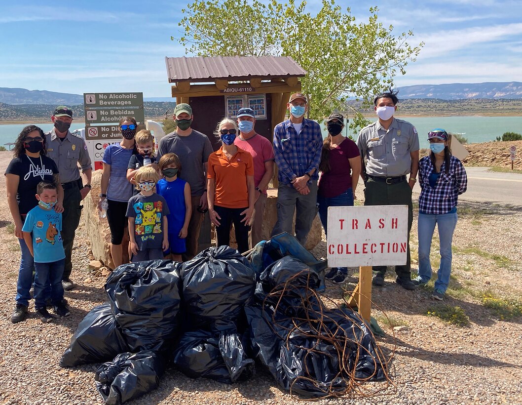 Abiquiu Lake project staff; Mark Yuska, chief of the USACE-Albuquerque District’s Operations Division; Albuquerque District commander Lt. Col. Patrick Stevens and his family; Tori White, USACE-South Pacific Division chief of Operations and Regulatory; and Abiquiu Lake park ranger Nathaniel Naranjo stand next to some of the trash collected during Abiquiu Lake’s NPLD event, Sept. 26, 2020.