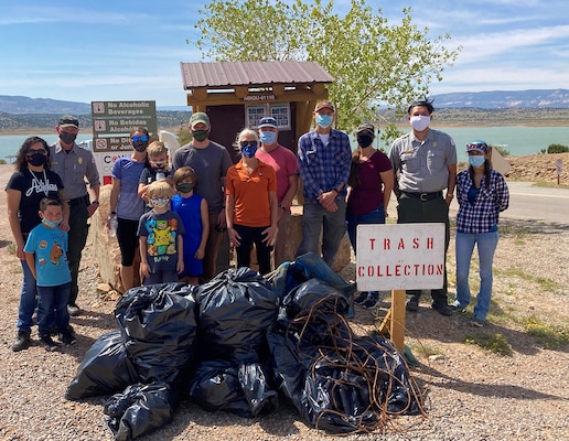 Abiquiu Lake project staff; Mark Yuska, chief of the USACE-Albuquerque District’s Operations Division; Albuquerque District commander Lt. Col. Patrick Stevens and his family; Tori White, USACE-South Pacific Division chief of Operations and Regulatory; and Abiquiu Lake park ranger Nathaniel Naranjo stand next to some of the trash collected during Abiquiu Lake’s NPLD event, Sept. 26, 2020.