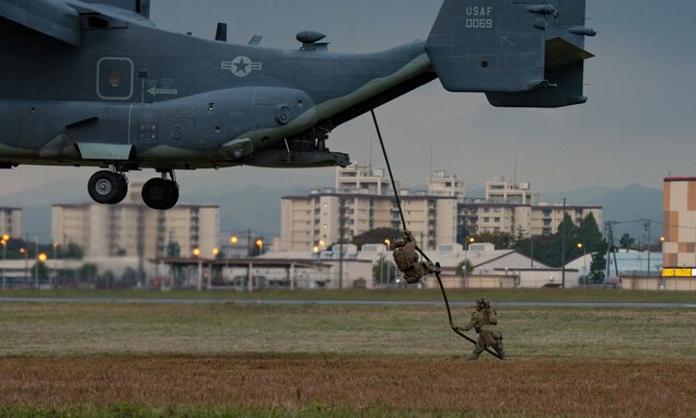 Members of the 320th Special Tactics Squadron and Charlie Company, 1st Battalion, 1st Special Forces Group (Airborne) descend from a CV-22 Osprey during a fast rope and hoist training as part of exercise Keen Sword 21, at Yokota Air Base, Japan, Nov. 3, 2020. Units from the 374th Airlift Wing, and from the 353rd Special Operations Group accomplished a variety of missions alongside their JSDF and joint partners across the Kanto Plains, allowing the enhancement of bilateral operations between the U.S. and Japan.