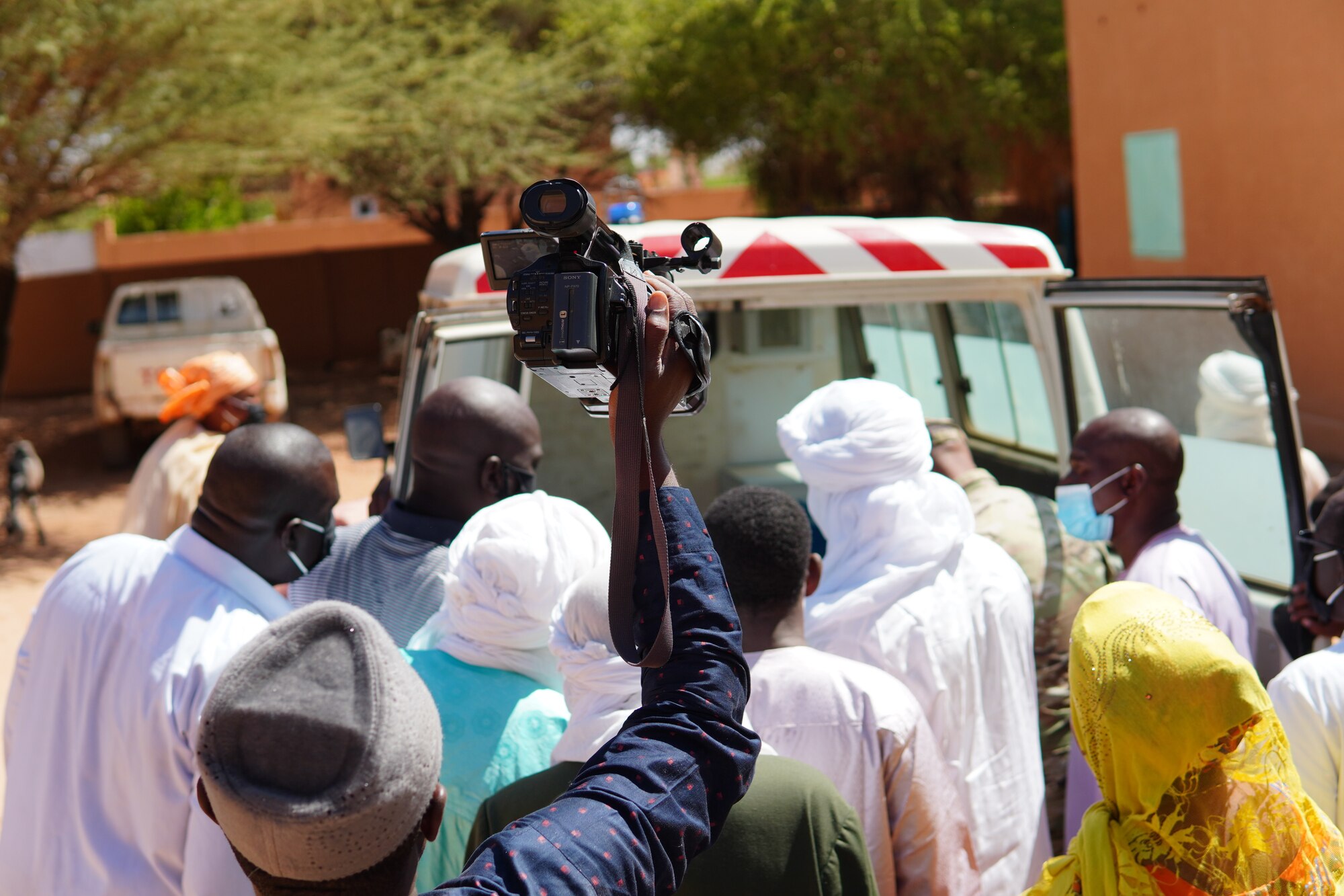 Medical staff with the District Sanitaire Commune d'Agadez clinic and local media get their first look at the newly restored ambulance delivered to the clinic in Agadez, Niger, Oct. 30, 2020. Thanks to the 724th Logistics Readiness Flight mechanics and the generosity of the Airmen of Nigerien Air Base 201, the city of Agadez now has one operable, serviceable and safe ambulance.