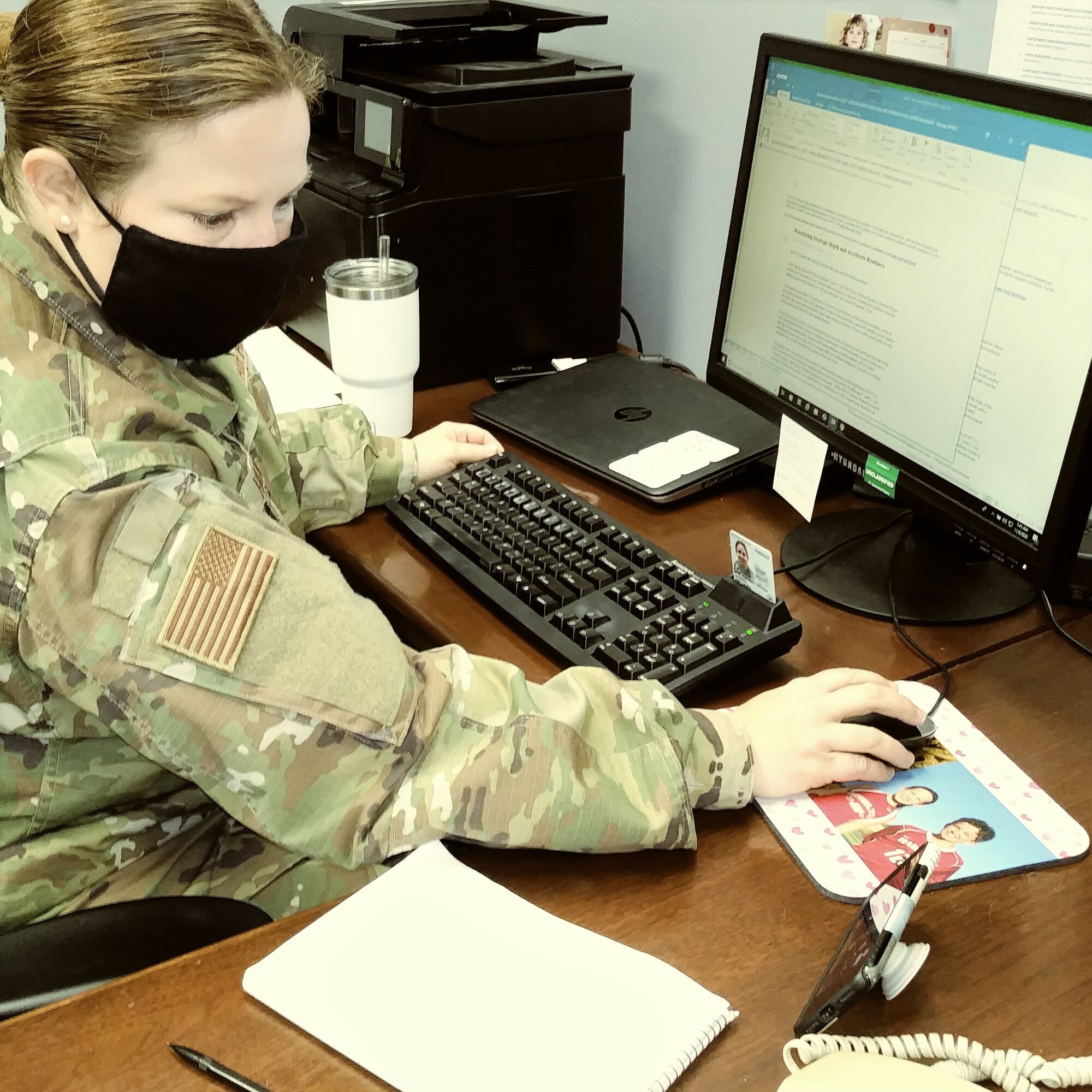 Lt. Col. Amy Hansen, 940 ARW inspector general views the event form her smart phone as she takes notes on her work station.