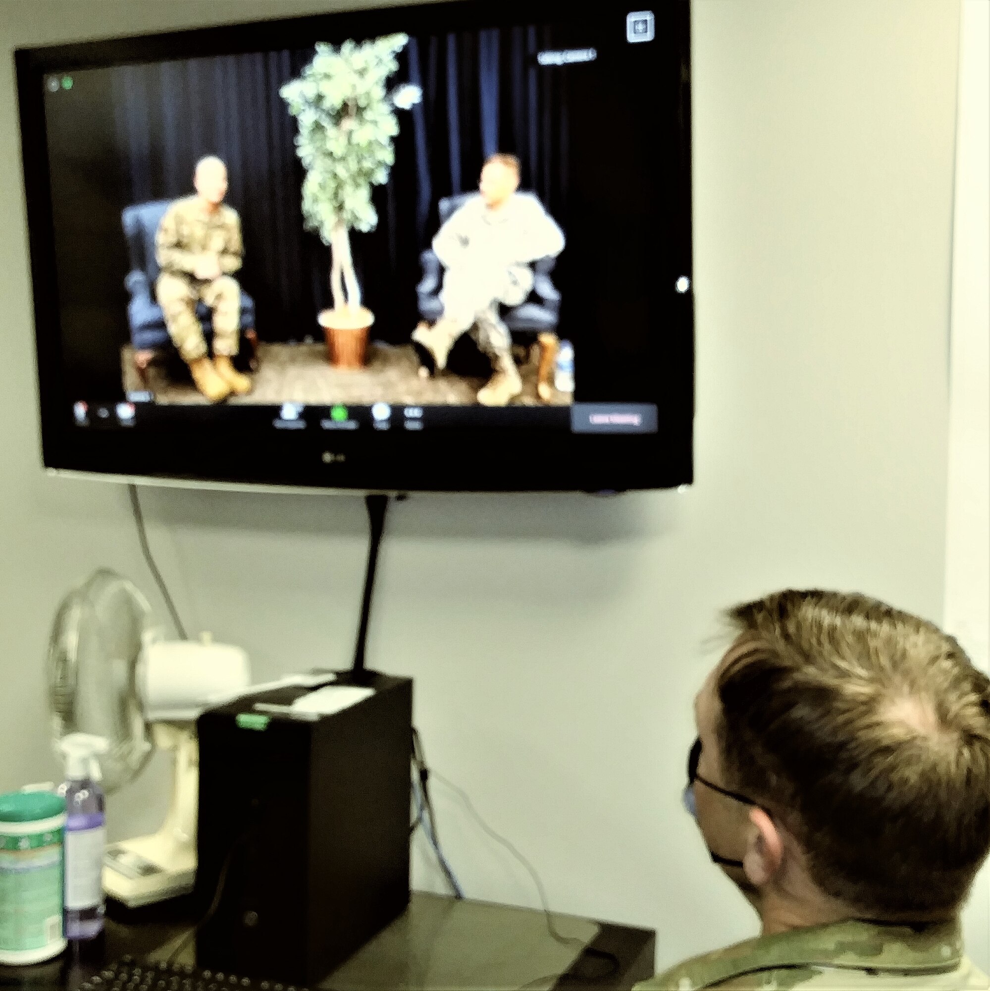 The safety office personnel listen and watch the commander and the acting  command chief take questions.