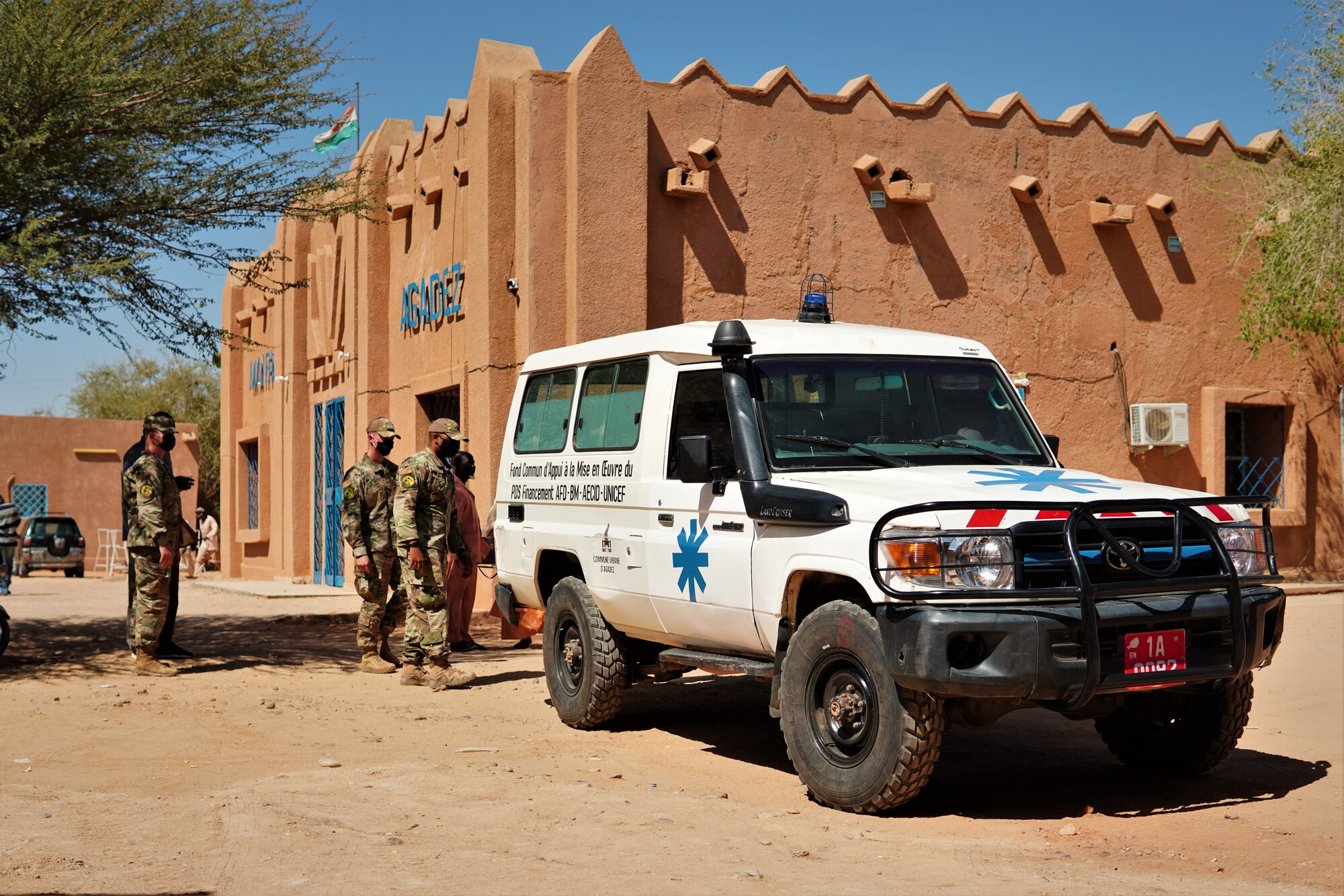 Members of the 724th Expeditionary Air Base Squadron and Civil Affairs Team deliver a fully functional ambulance and life-saving medical equipment to the District Sanitaire Commune d'Agadez clinic in Agadez, Niger, Oct. 30, 2020. Members of the Nigerien Air Base 201 Civil Affairs Team identified the need to repair one of the two publicly-owned ambulances servicing the city of Agadez.